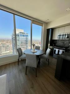 a living room with a table and chairs and a large window at The Daisy-Highrise 2BR Marina View,Pool,Jacuzzi,Gym&Parking in San Diego