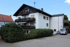 a white building with balconies on the side of it at Gasthof und Pension zum Löwen in Hirschberg an der Bergstraße