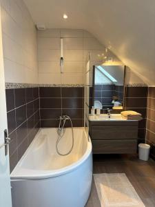a large bathroom with a tub and a sink at Maison avec terrasse et jardin in Avallon +19 photos