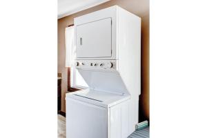 a white washer and dryer in a room at Lake Huron Getaway by arc Vacation Rentals in Lexington +17 photos