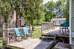 a deck with chairs and a bench on a house at Lake Huron Getaway by arc Vacation Rentals in Lexington