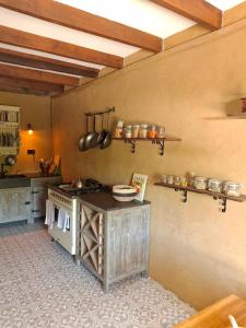 a kitchen with a stove and some pots and pans at L'Amour Triomphe in Rempnat