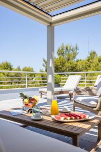 a wooden table with fruit on a patio at Beachfront penthouse Residence in Podstrana