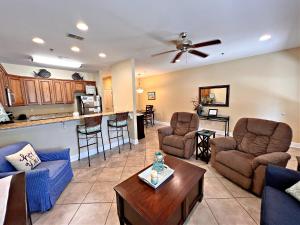 a living room filled with furniture and a kitchen at Laguna Breeze in Gulf Shores