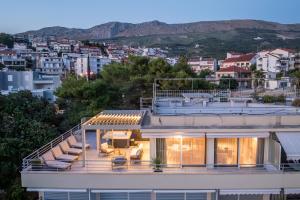 a house with a view of a city at Beachfront penthouse Residence in Podstrana