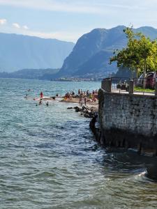 a group of people on a beach in the water at Blue Lake in Acquaseria +28 photos