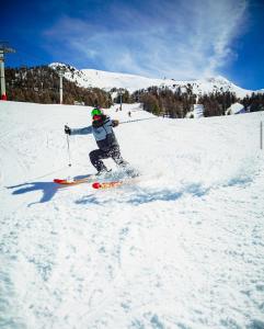 a person is skiing down a snow covered slope at AL Cosy in Vars Ski & Nature in Vars