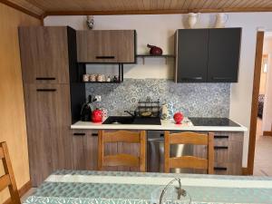 a kitchen with black cabinets and a counter top at Le bureau in Digoin