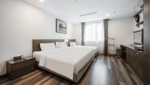 Postel nebo postele na pokoji v ubytování A25 Hotel - Hoàng Đạo Thúy 1