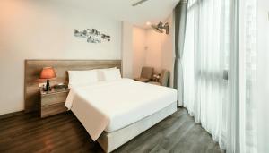 Postel nebo postele na pokoji v ubytování A25 Hotel - Hoàng Đạo Thúy 1