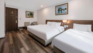 Postel nebo postele na pokoji v ubytování A25 Hotel - Hoàng Đạo Thúy 1