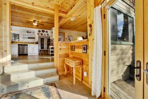 a wooden cabin with a kitchen and a dining room at Pleasant Pause#1864 in Fawnskin