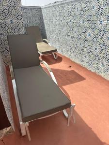 a couple of chairs sitting on a balcony at Superbe appartement centre Agadir 10mn à pied plage in Agadir