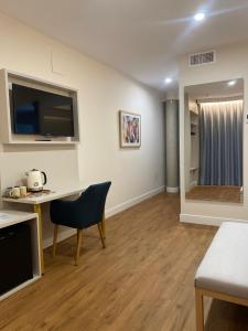 a living room with a desk and a television at Hotel Boutique La Brisa del Mar in Estepona +50 photos