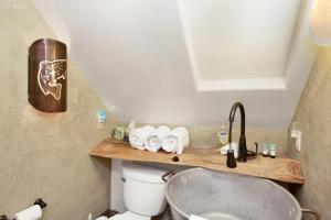 a bathroom with a sink and a toilet at Maltby modern log cabin #2307 in Big Bear City +22 photos