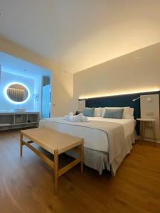 a large bedroom with a large bed and a table at Hotel Boutique La Brisa del Mar in Estepona