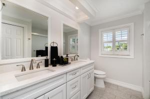 a white bathroom with a sink and a toilet at La Dolce Vita Your Waterfront Jackpot in North Fort Myers +32 photos