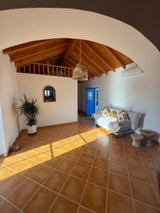 a living room with a couch and a wooden ceiling at Monte da Carrasqueira in Santiago do Cacém