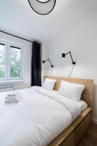 Postel nebo postele na pokoji v ubytování Osiedle Sobieskiego Comfort Apartment by BookingHost
