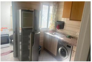 a kitchen with a refrigerator and a washing machine at Martil 2 bedroom apartment in Martil