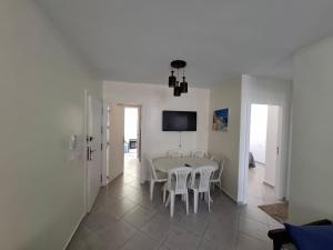 a white dining room with a table and chairs at Martil 2 bedroom apartment in Martil