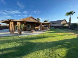 a house with a large lawn in front of it at Cadbury 4BR Outdoor Kitchen Sleeps 8 Peaceful in Bakersfield
