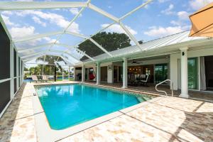 an image of a swimming pool in a house at La Dolce Vita Your Waterfront Jackpot in North Fort Myers