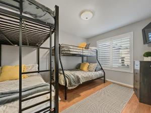 a bedroom with two bunk beds and a window at Kimberly Surprise in Surprise +39 photos
