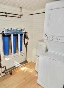 a kitchen with a stove and a white refrigerator at Lakefront Cottage by Country House Escapes in Lincolnville
