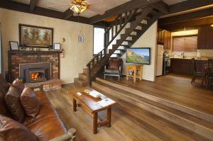 a living room with a couch and a fireplace at Juniper's Cottage - Secluded hideaway with a large fenced yard giving the feeling of privacy! in Big Bear City