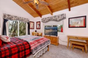 a bedroom with a bed and a flat screen tv at Moulin rouge #2055 in Big Bear Lake