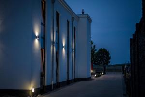 a building with lights on the side of it at night at Triumph Inn Pension in Rangsdorf