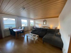 a living room with a couch and a table at FeWo Koch48 in Osann-Monzel