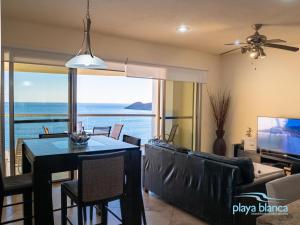 a dining room with a view of the ocean at Playa Blanca Premier Unit 1407 in San Carlos