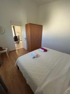 a bedroom with a large bed and a wooden cabinet at Apartmani Paklenica in Razvala
