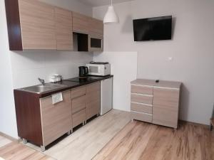 a small kitchen with a sink and a microwave at Apartament z tarasem in Bodzentyn