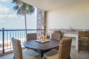 a dining room with a table and chairs and the ocean at Sonoran Sky in Puerto Peñasco