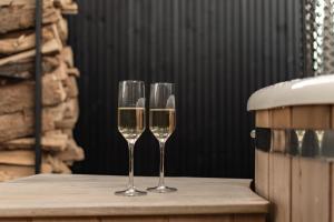 two wine glasses sitting on top of a table at B&B Buitengeluk in Kapel-Avezaath
