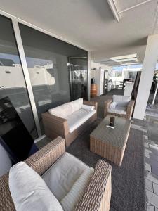a living room with a couch and chairs and a table at Casa do Mar Oeiras in Oeiras