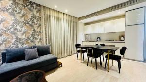 a living room with a couch and a table at City Center Apartment with Terrace in Casablanca
