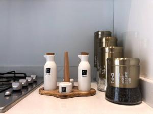 a kitchen counter with some bottles and a stove at City Center Apartment with Terrace in Casablanca