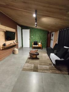 a living room with a couch and a table at Pousada Rural Sitio Bela Açucena in Braço do Norte