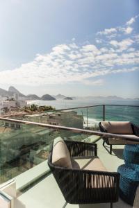 
a view from a balcony of a balcony overlooking the ocean at Ritz Copacabana Boutique Hotel in Rio de Janeiro
