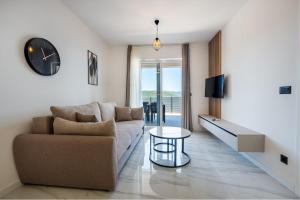 a living room with a couch and a clock on the wall at Villa Kristina in Neum