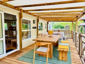 a wooden deck with a wooden table and chairs at My Maui Home in Salles