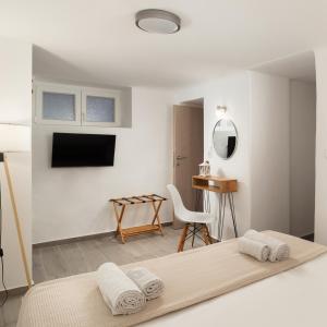 アンドロスにあるDK Square 3のベッドと机と椅子のある寝室