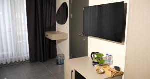 a room with a flat screen tv on a wall at Zulu Suites in Istanbul