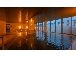 a swimming pool in a building with windows at Yunoko Umi To Yuyake - Vacation STAY 56102v in Minamata +35 photos