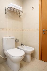 a bathroom with a toilet and a sink at Ruwi Hotel Apartments, Sharjah in Sharjah +5 photos