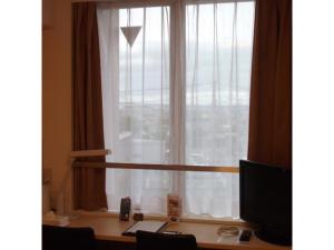 a desk in front of a window with a computer at Quad Inn Yokote - Vacation STAY 57397v in Yokote +28 photos
